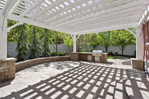 View of patio / terrace featuring area for grilling, a fenced backyard, grilling area, and a pergola