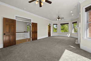 Carpeted spare room featuring a ceiling fan, crown molding, baseboards, and recessed lighting