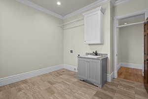 Laundry area with washer hookup, electric dryer hookup, ornamental molding, baseboards, and recessed lighting