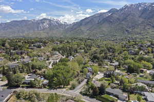 Aerial overview of property's location featuring mountains and nearby suburban area
