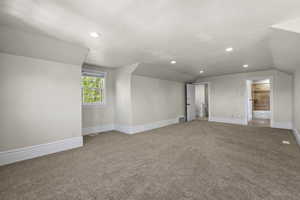 Additional living space featuring carpet, lofted ceiling, recessed lighting, and baseboards