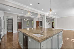 Kitchen featuring a sink, dark wood-style flooring, recessed lighting, a kitchen island with sink, and open floor plan