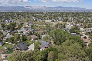 Aerial overview of property's location featuring a mountain backdrop and nearby suburban area
