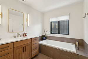 Full bathroom with vanity, a bath, and tile patterned floors