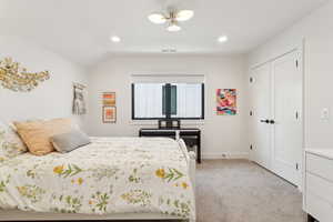 Bedroom with light carpet, recessed lighting, a closet, vaulted ceiling, and baseboards