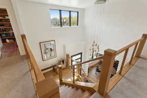 Stairs with wood finished floors and baseboards