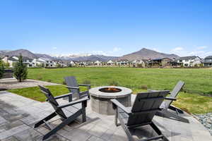 View of patio with a fire pit, a mountain view, and a residential view