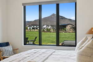Bedroom with multiple windows, a mountain view, and a residential view