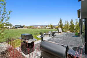 View of patio / terrace featuring a fire pit, a mountain view, and area for grilling