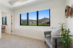 Sitting room with carpet floors, baseboards, and a mountain view