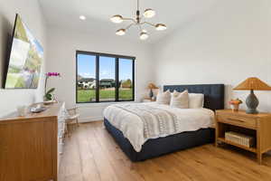 Bedroom featuring a chandelier, light wood-style flooring, baseboards, recessed lighting, and vaulted ceiling