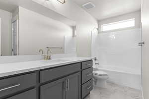 Full bath with tub / shower combination, vanity, and light marble finish flooring