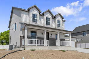 View of front of property with a porch, brick siding, a garage, and concrete driveway