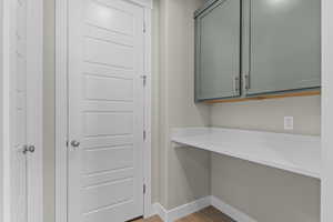 Doorway to outside featuring baseboards and wood finished floors