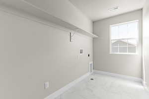 Washroom featuring light marble finish floors, hookup for an electric dryer, and washer hookup