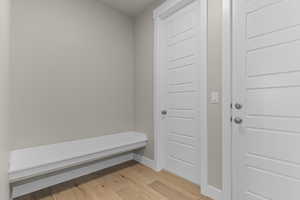 Mudroom with light wood-style floors and baseboards