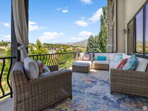 Exterior space featuring a balcony, an outdoor hangout area, and a mountain view