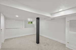 Basement with carpet flooring, baseboards, and recessed lighting