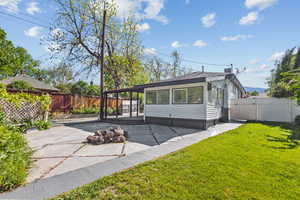 Back of property with a patio and a gate
