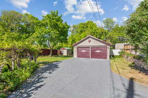 Detached garage featuring a shed