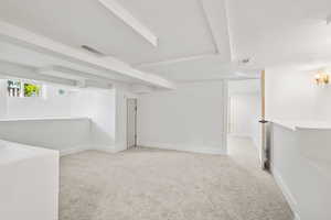 Below grade area featuring carpet and baseboards