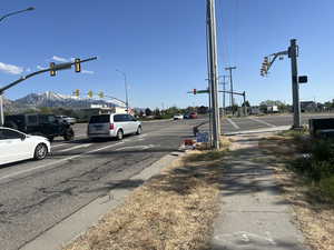 View of asphalt road with traffic and street lights