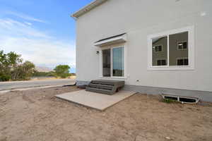 Rear view of property with stucco siding and a mountain view