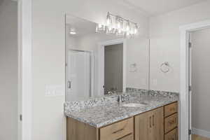 Bathroom featuring vanity and a stall shower