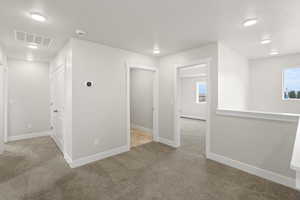 Bonus room with light carpet, a textured ceiling, healthy amount of natural light, and recessed lighting