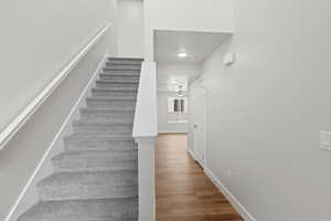 Stairway featuring wood finished floors and baseboards