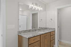 Full bathroom with vanity, a stall shower, and light tile patterned flooring