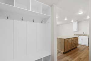 Mudroom featuring dark wood finished floors and a textured ceiling