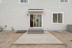 Property entrance featuring a patio area and stucco siding
