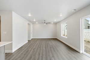 Unfurnished living room featuring light wood finished floors, a ceiling fan, and recessed lighting
