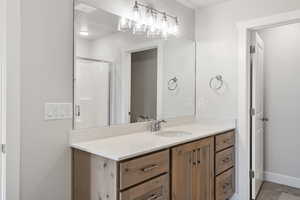 Full bathroom featuring vanity and a shower stall