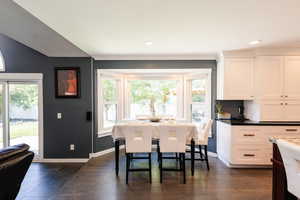 Dining room featuring dark wood finished floors, recessed lighting, and baseboards