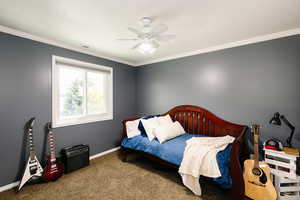 Bedroom featuring carpet, baseboards, crown molding, and a ceiling fan