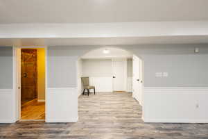 Below grade area with LVP finished floors and arched walkways