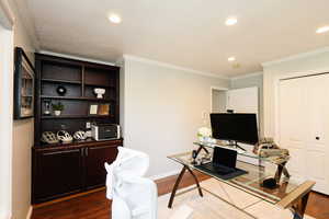 Home office featuring dark wood finished floors, recessed lighting, crown molding, and baseboards