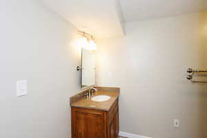 Bathroom with vanity and a textured ceiling