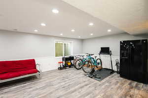 Exercise room with LVP finished floors, recessed lighting, and baseboards
