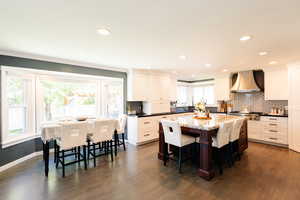 Dining space featuring healthy amount of natural light, recessed lighting, dark wood-style floors, ornamental molding, and baseboards