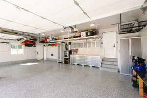Garage with a garage door opener and baseboards