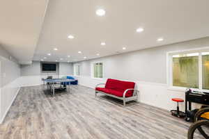 Rec room featuring LVP finished floors, recessed lighting, and baseboards