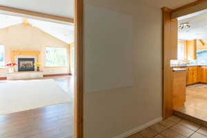 Corridor with plenty of natural light, baseboards, and light tile patterned floors