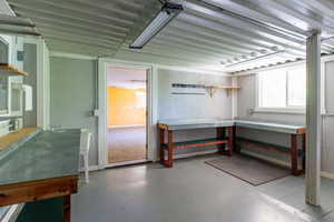 Basement featuring a workshop area and baseboards