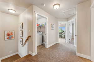 an upstairs landing / hallway with attic access, carpet