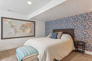 Basement bedroom with carpet floors, baseboards, wallpapered walls, and recessed lighting