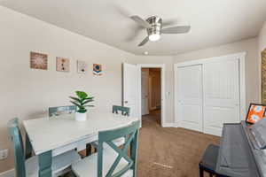 Top floor bedroom featuring ceiling fan, being used an office