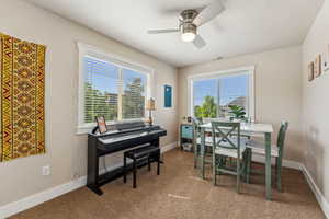 Top floor bedroom featuring ceiling fan, being used an office